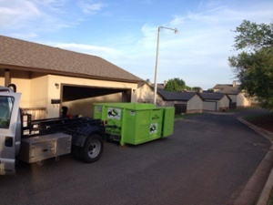 Bin There Dump That dumpster and truck at house